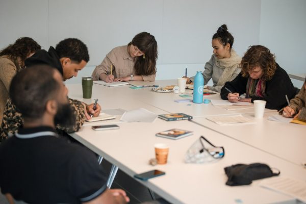 A group of teachers takes part in a poetry-centered curriculum workshop.