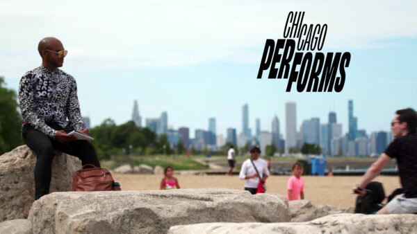 A male-presenting person with dark skin sits on a rock at a beach with Chicago's skyline in the background. Black text above reads Chicago Performs.