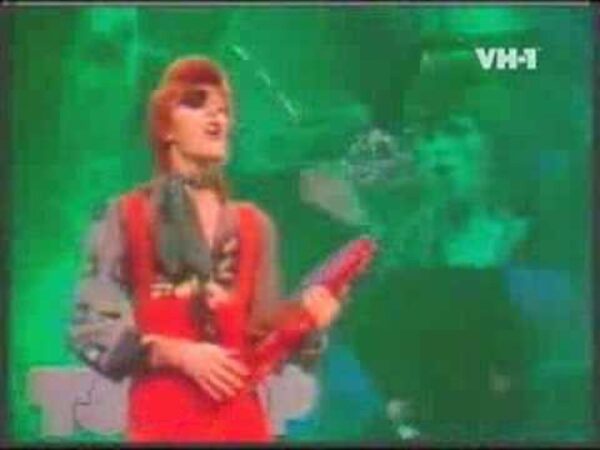 A very grainy image of David Bowie against a green screen from his Rebel Rebel video