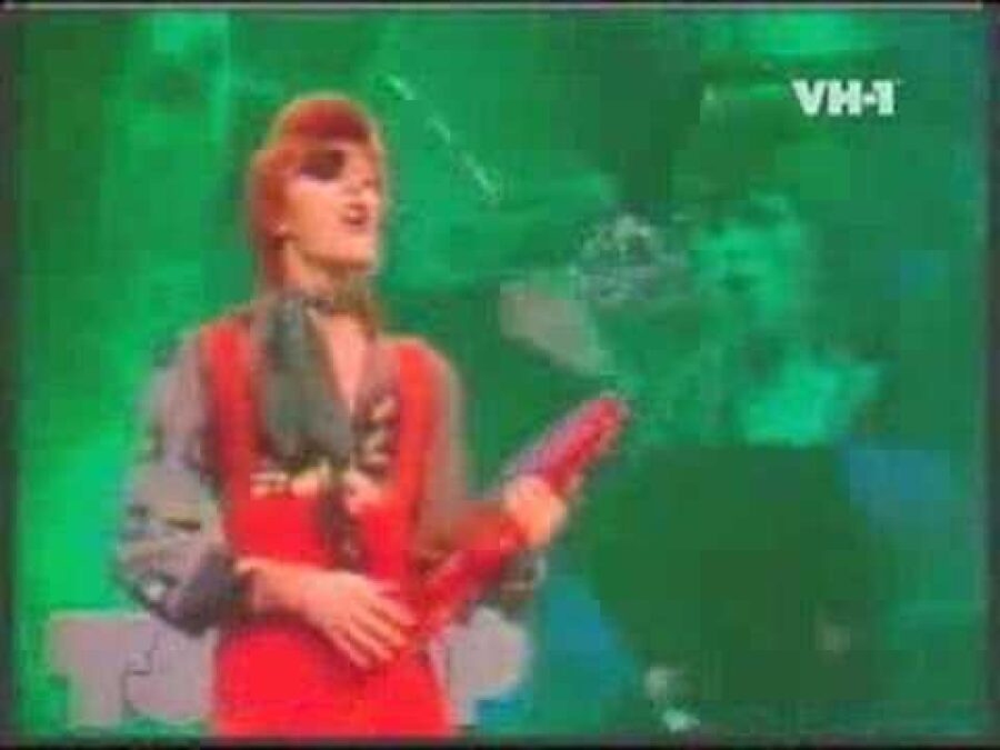 A very grainy image of David Bowie against a green screen from his Rebel Rebel video