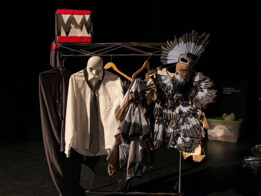 Costumes on a rack in a dark room