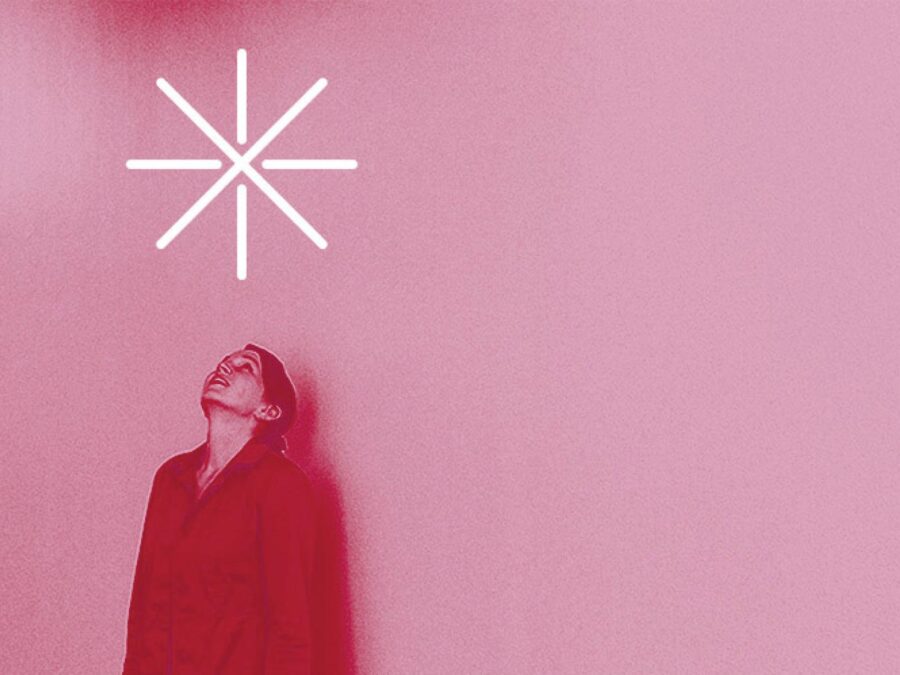 A fuschia tinged image of a person looking up at a large asterisk