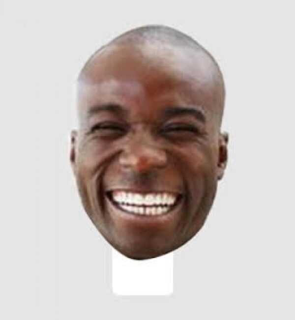 Cutout of a the face of a smiling male-presenting person with dark skin