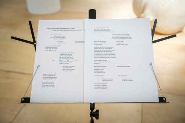 Music stand with two white pages on it filled with text in various columns
