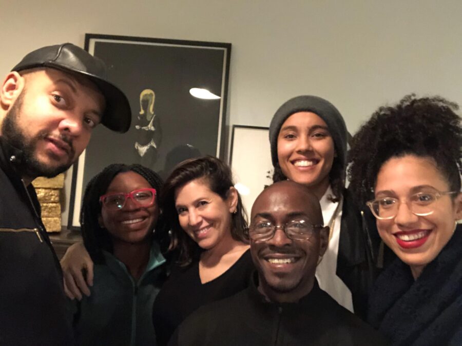 A group of six people gathered tightly together to fit into the frame