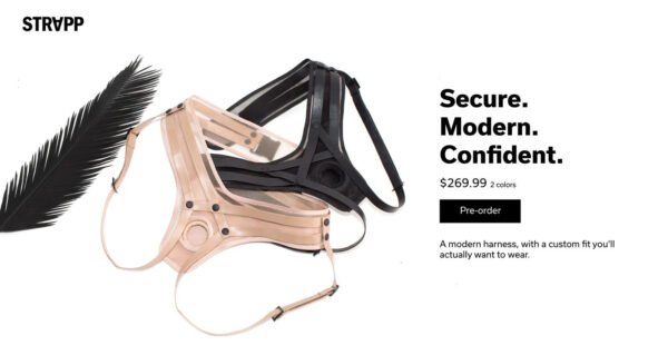 A black feather brushes up against the leg strap of an ivory strap-on, which is interlaced with a black strap-on. The words Strapp and Secure. Modern. Confident. appear on the image with the price $269.99 two colors above a pre-order button.