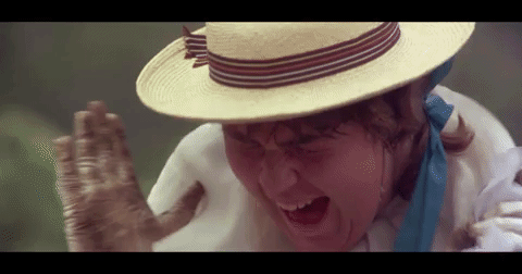 A close-up of female wearing straw hat screaming is interspersed with the words TERROR/TERRA NULLIUS flashing over a barren landscape.