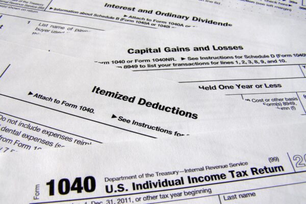 Sections of the 1040 tax document spread out in descending order so the tops of the pages are seen