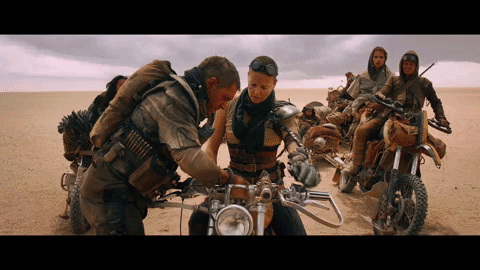 A close up of a tape inserted into an audio recorder switches to a scene of Furiosa looking questioningly at Max from Mad Max: Fury Road.
