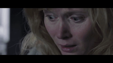 Essie Davis reads a pop-up book featuring the Babadook with rainbow-colored teeth.