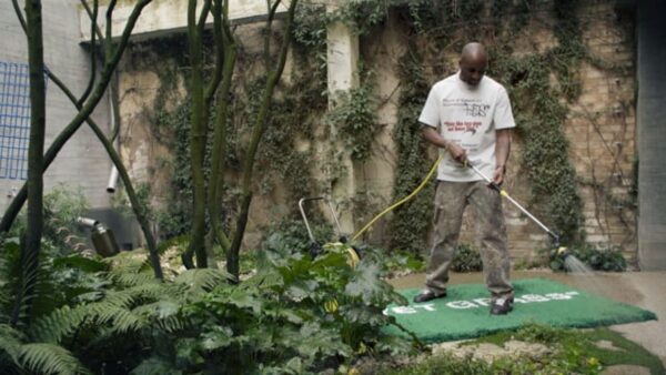 Virgil Abloh watering a garden while standing on his 