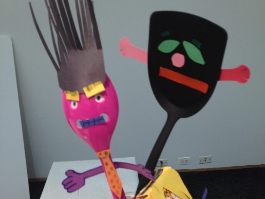 Plastic spoons and cardboard packaging all with paper faces on them