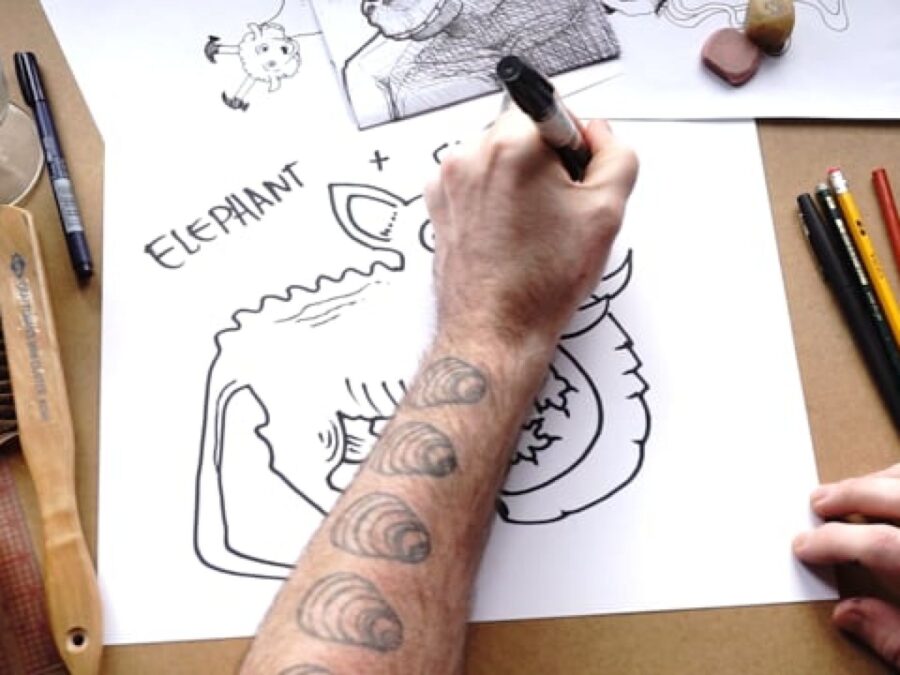 View of a left arm with seashell tattoos going up in drawing with a sharpie