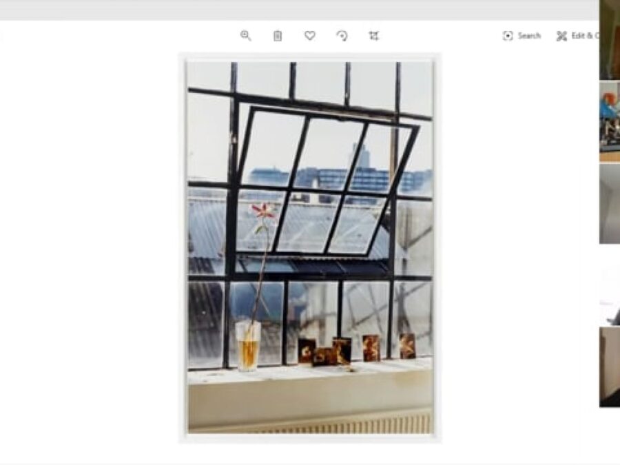 Five small screens in a column to the right of an image of an old warehouse window with the middle open just slightly and a variety of objects lining the window sill
