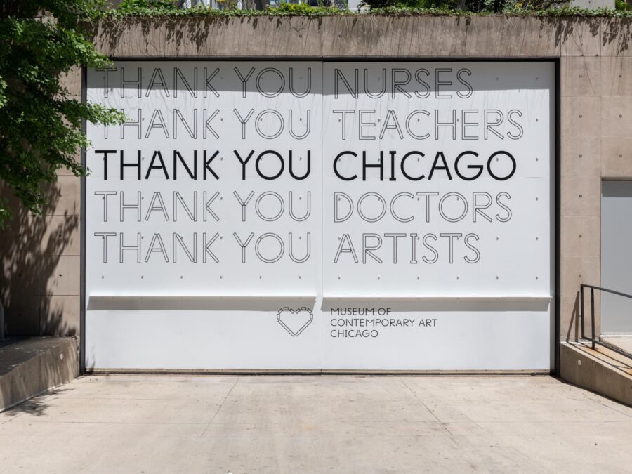 A large garage door with a full decal of text expressing thanks to Nurses, Teachers, Chicago, Doctors, and Artists.