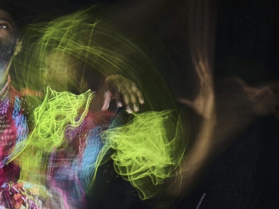 Two people in a colorful haze against a black background with text below them reading Nick Cave Jack Cave The Color Is