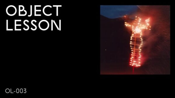 A black rectangle with the words Object Lesson in the upper left hand corner and OL 003 in the bottom left hand corner accompanied by an image of a burning human effigy on the right hand side