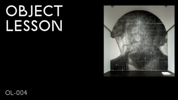 A black rectangle with the words Object Lesson in the upper left hand corner and OL 004 in the bottom left hand corner accompanied by an image of a smoky portrait of a person encompassing a full arched wall in the upper right hand corner