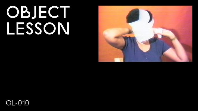 A black rectangle with the words Object Lesson in the upper left hand corner and OL 010 in the bottom left hand corner accompanied by an image of a person wrapping their head in white fabric in the upper right hand corner
