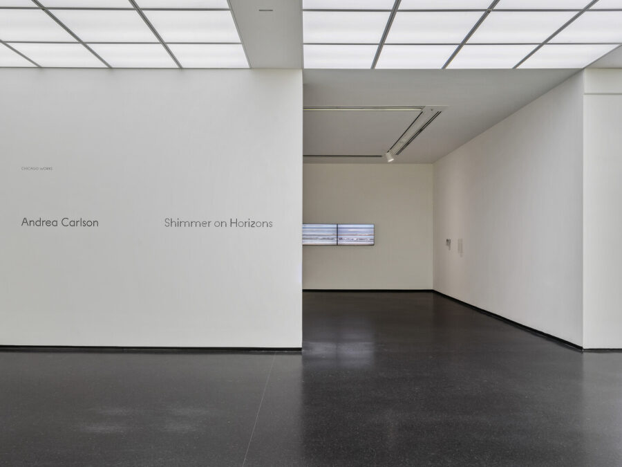 Entrance to a gallery space with the exhibition name on the left side of the entrance reading Andrea Carlson Shimmer on Horizons