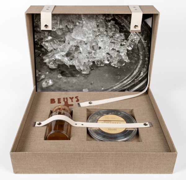 An open suitcase filled with a variety of objects.
