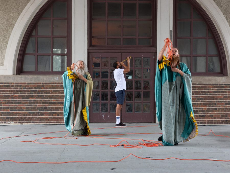 Performance still with three performers.