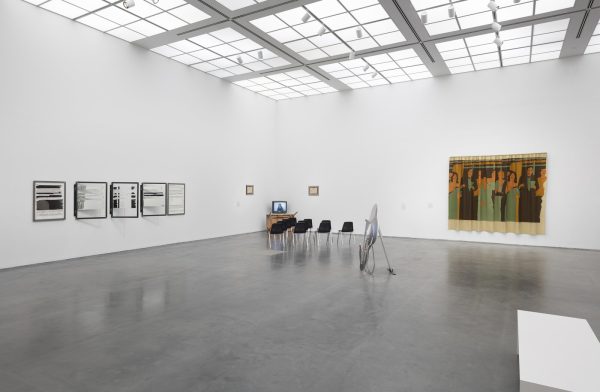 Large, white gallery space with four artworks visible. Two are hung on the wall; two are installations.