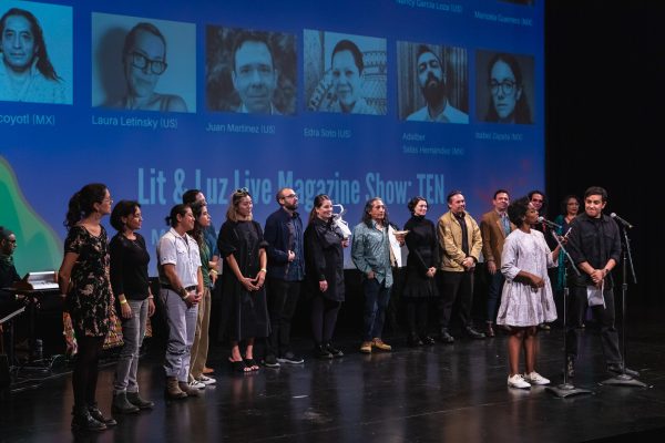A large group of people stand in line on a stage
