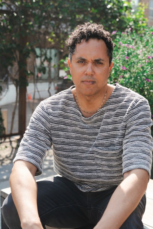 Portrait of a man with short curly hair in an outdoor location