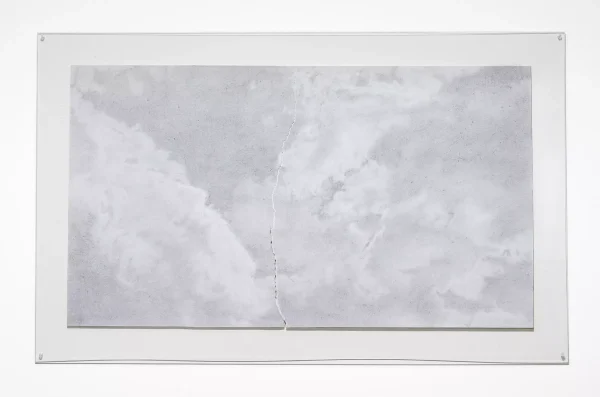 faint cloudy grey textures drawn on torn white paper