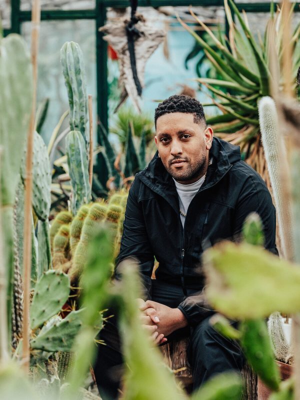Photo of Joseph Henry surrounded by cacti.