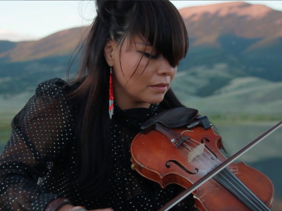 Close up of woman playing violin outdoors