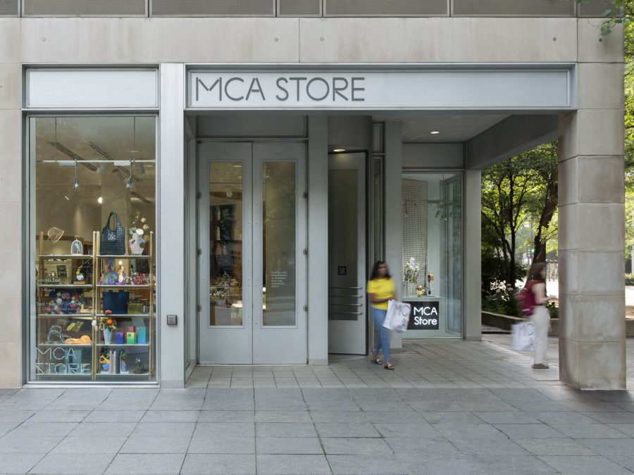 The exterior of the MCA Store with two shoppers exiting with bags