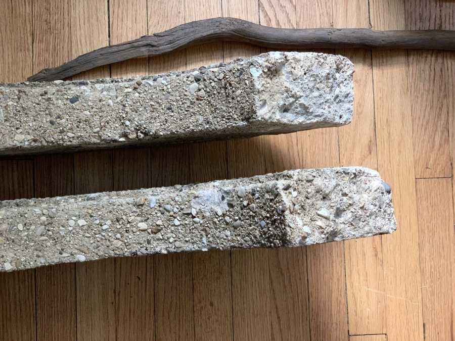 Two thing pieces of concrete on a wooden floor