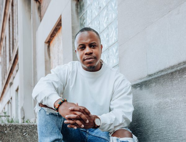 Cropped image of a black man wearing a white sweatshirt