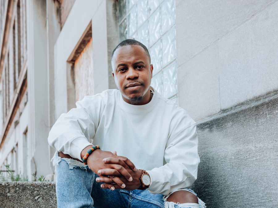 Cropped image of a black man wearing a white sweatshirt