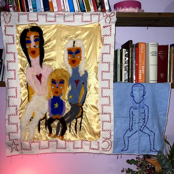 Two bookshelves covered with tapestries of people.