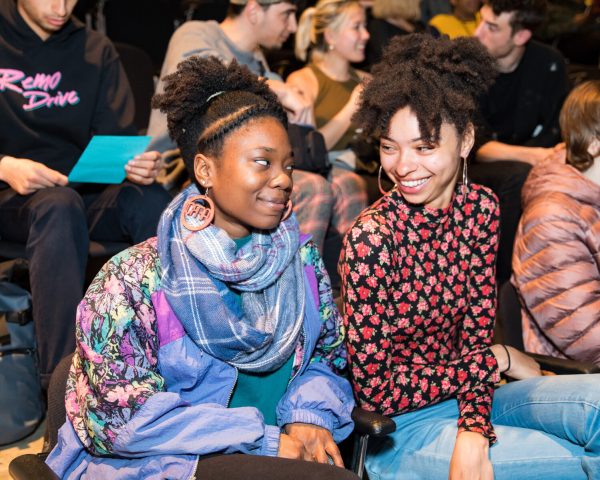 Photo of two people looking at each other smiling.