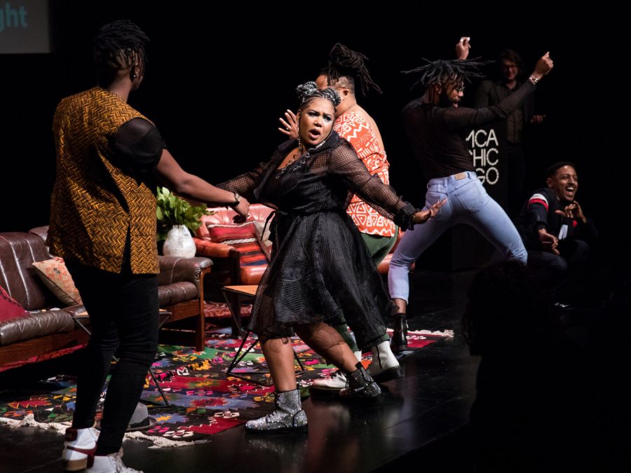 Photo of performers onstage singing and dancing.