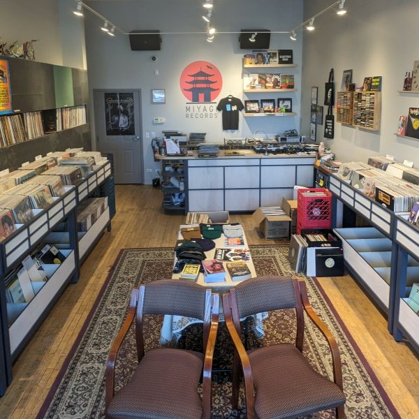 The interior of a record store with two tiered bins living three walls of the space