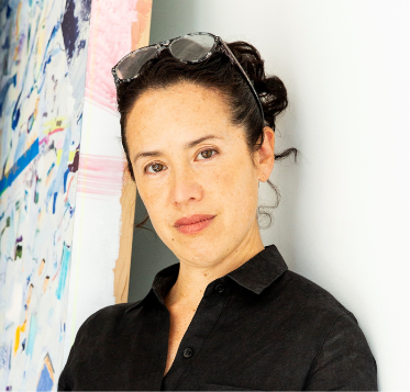 Portrait of artist Sarah Sze next to a painting that is mostly cut out of the picture