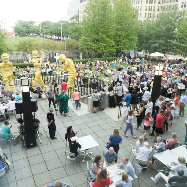 A crowd spread out on the MCA's lawn in their sculpture garden.