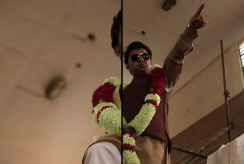 A split image: On the right-hand side a man wearing sunglasses and a jaimala pointing off to the right as viewed from below. The left-hand side of the image is an intense close-up of the scene with a sliver of the man as viewed from the left.