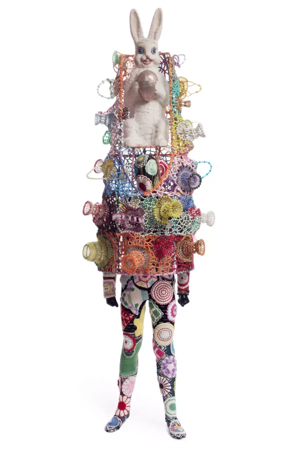 Mixed media including vintage bunny, safety pin craft baskets, hot pads, fabric, metal, and mannequin