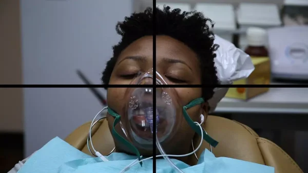 Image of a person with a laughing gas mask divided into four sections by a crossbar line.