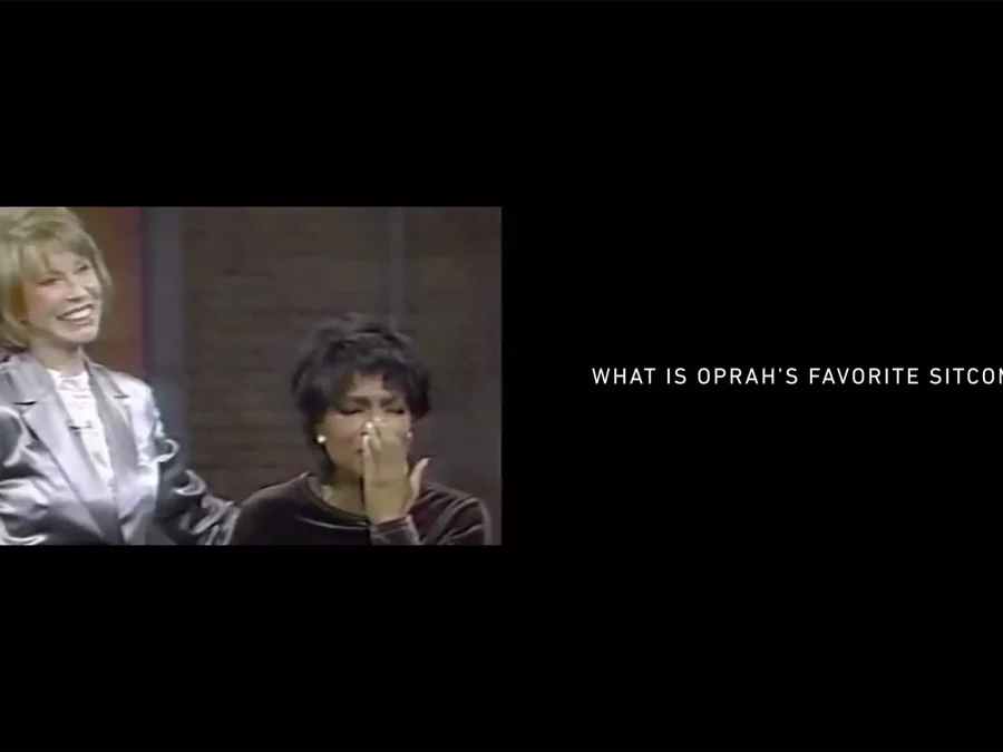Archival still from the Oprah Winfrey Show with the caption 'what is Oprah's favorite sitcom'