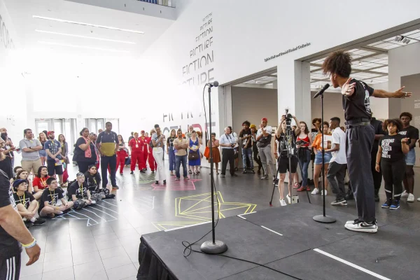 view from behind stage as audience watches performer on stage
