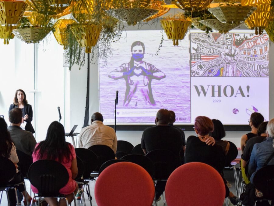 Woman presents a slideshow to a group of people.