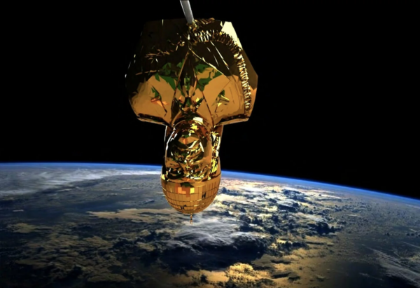 A gold bust of Saddam Hussein hangs upside down above Earth