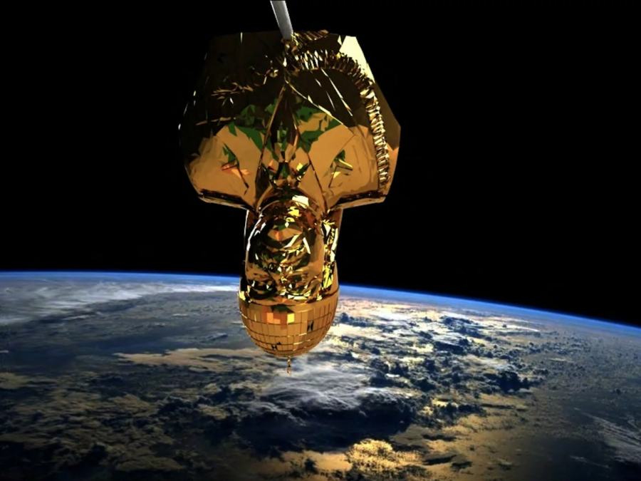 A gold bust of Saddam Hussein hangs upside down above Earth